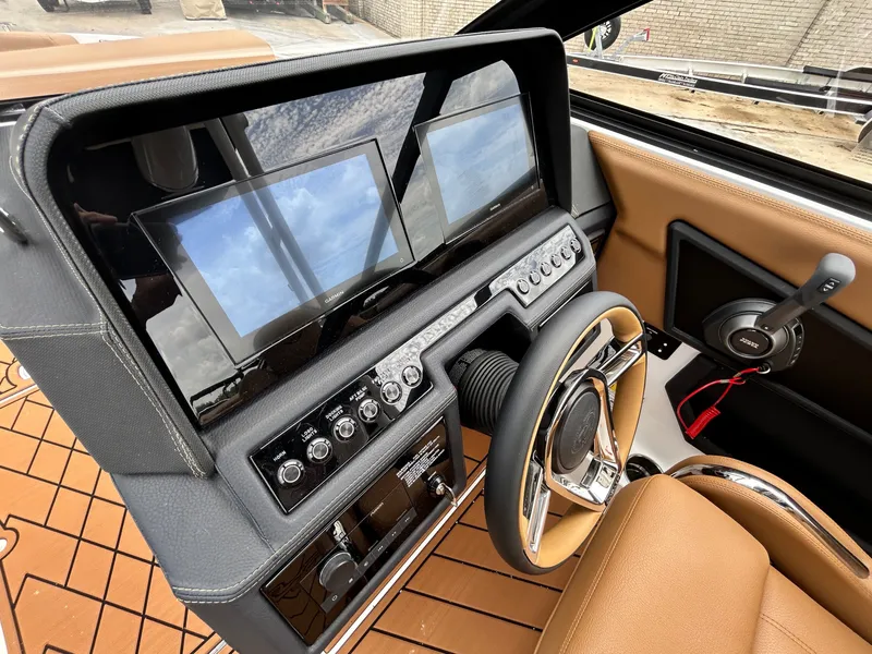 Slide: The Image of The image shows the cockpit of a 2027 Cobalt R4 boat with modern instruments and a sleek steering wheel. - 30
