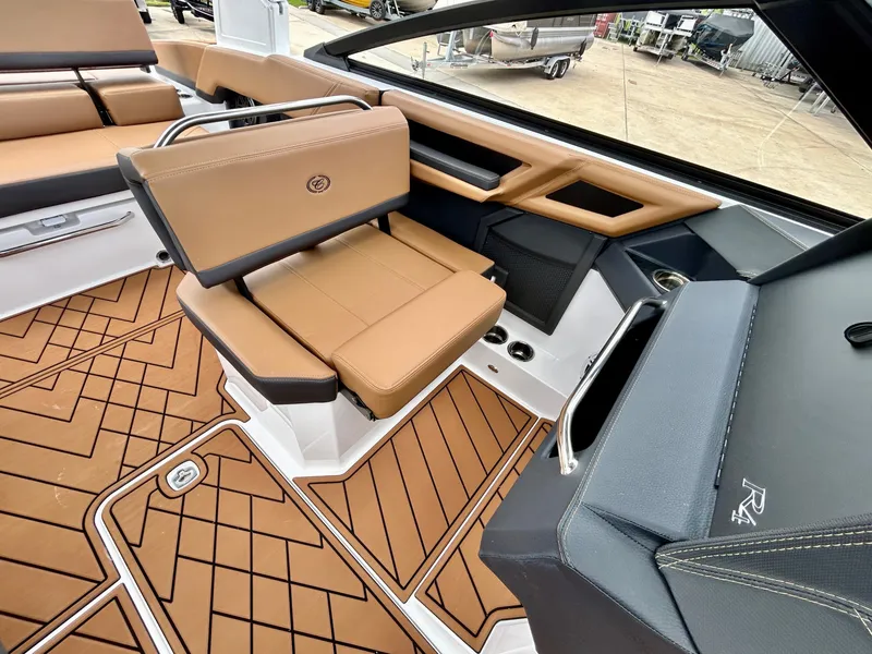 Slide: The Image of The image shows the interior of a 2027 Cobalt R4 boat with sleek brown seating. - 36