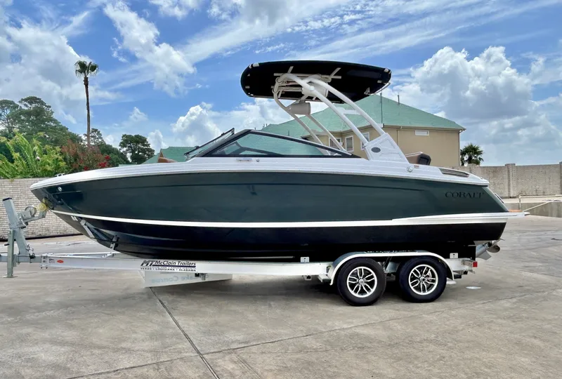 Slide: The Image of A sleek 2027 Cobalt R4 boat on a trailer, parked in front of a house. - 4