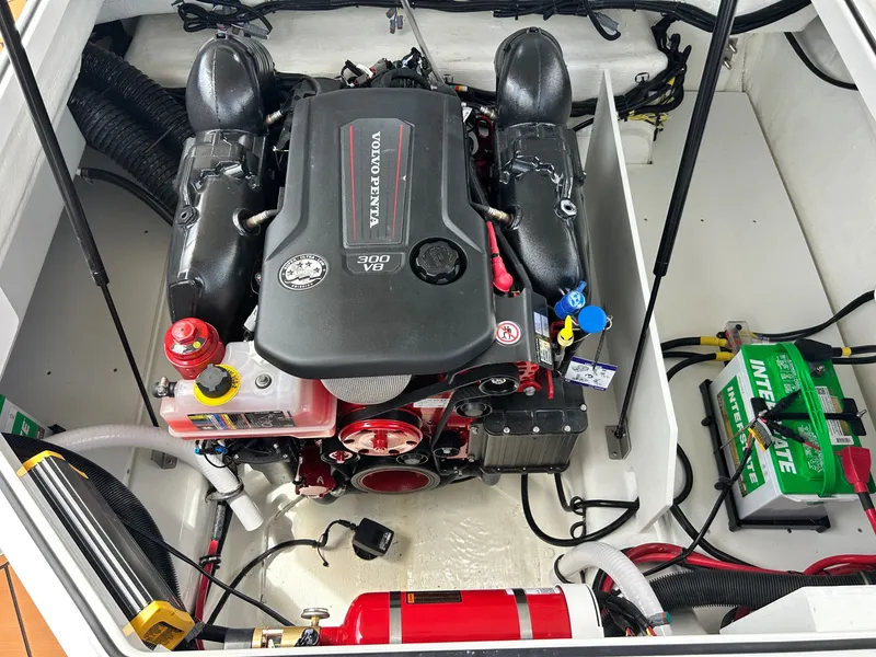 Slide: The Image of The engine compartment of a 2027 Cobalt R4 boat features a Volvo Penta engine and a battery. - 49