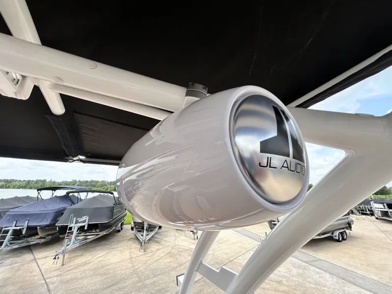 Slide: The Image of Close-up of a JL Audio speaker on a Cobalt R4 boat, with other boats in the background. - 42