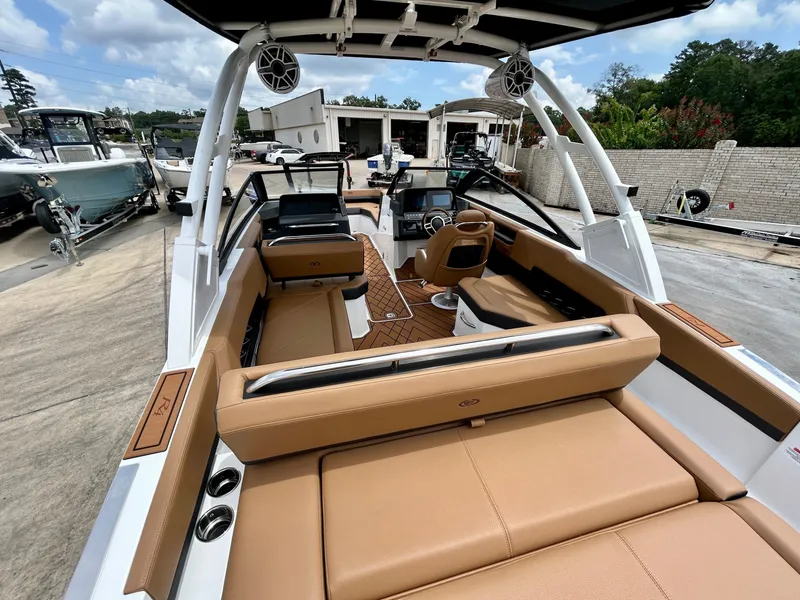 Slide: The Image of The image shows the interior of a 2027 Cobalt R4 boat with beige leather seating. - 16