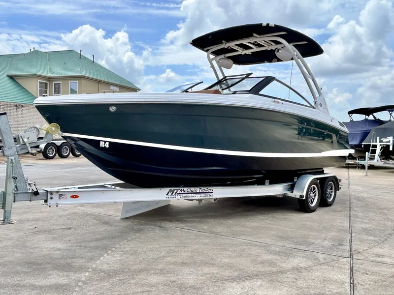 Slide: The Image of A 2027 Cobalt R4 boat on a trailer. It features a sleek, modern design. - 6