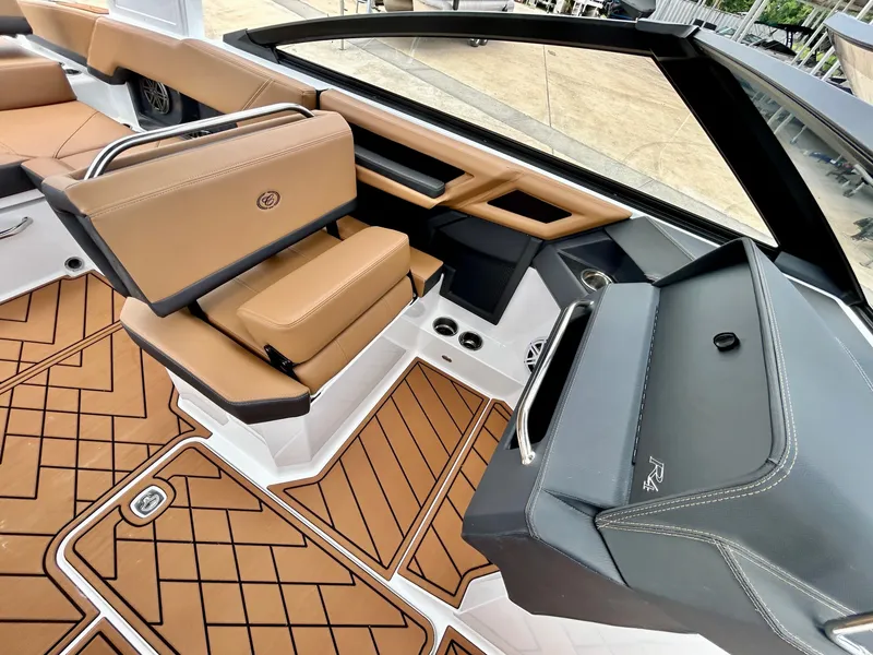 Slide: The Image of The image shows the cockpit of a 2027 Cobalt R4 boat with brown seating and flooring. - 35