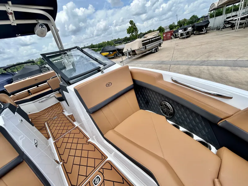 Slide: The Image of The image shows the interior of a 2027 Cobalt R4 boat with brown leather seats. - 24