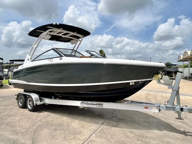 Slide: The Image of A 2027 Cobalt R4 boat sits on a trailer under a cloudy sky. - 5
