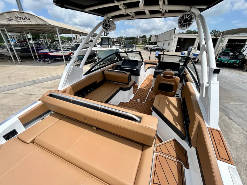 Slide: The Image of The image shows the interior of a 2027 Cobalt R4 boat with brown leather seating. - 17