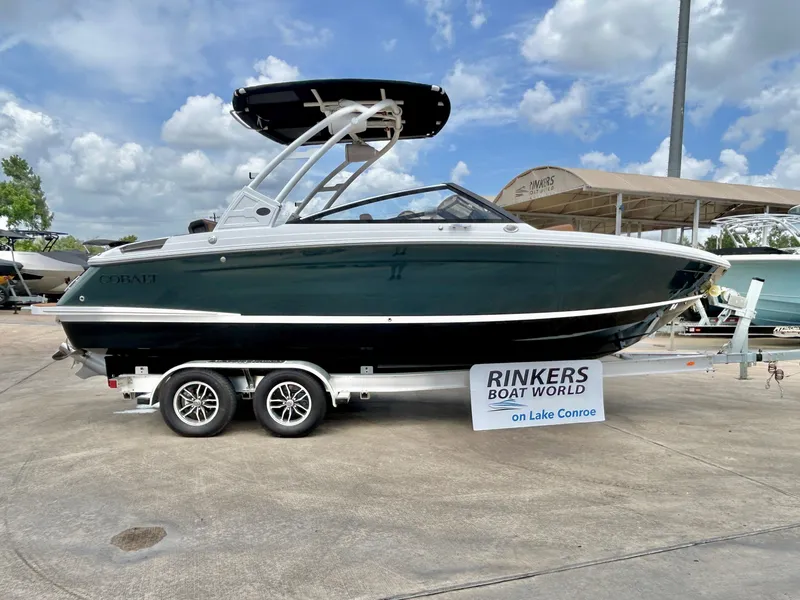 Slide: The Image of A 2027 Cobalt R4 boat on a trailer. It features a black canopy and is displayed at Rinkers Boat World. - 2