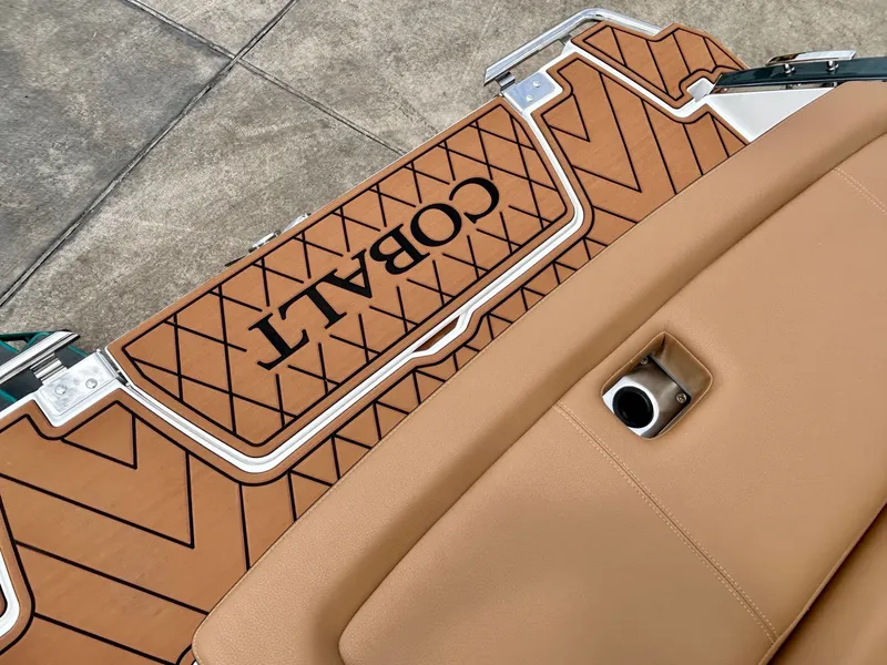 Slide: The Image of Close-up of the Cobalt R4 boat deck with brown upholstery and stylish design. - 14