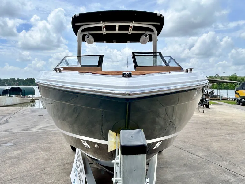Slide: The Image of A modern Cobalt R4 boat from 2027 sits on a trailer, ready for the water. - 10