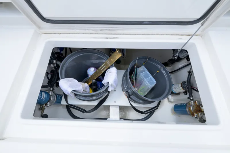 Slide: The Image of Storage compartment of 2022 Regulator 34 Center Console with fishing gear and supplies. - 17