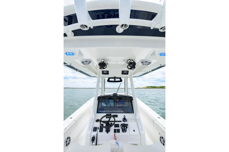 Slide: The Image of 2022 Regulator 34 Center Console boat interior with advanced navigation system on open water. - 14