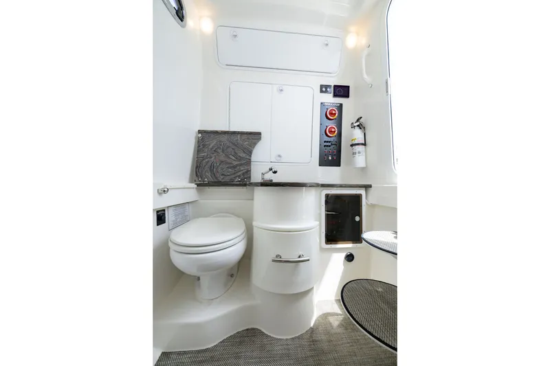 Slide: The Image of 2022 Regulator 34 Center Console boat interior with toilet and control panel. - 31
