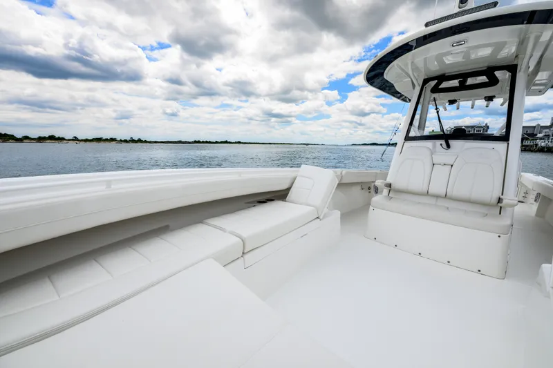 Slide: The Image of 2022 Regulator 34 Center Console boat interior with seating, on a calm water backdrop. - 25