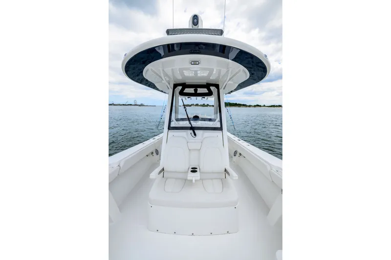 Slide: The Image of 2022 Regulator 34 Center Console boat on calm water, showcasing sleek design and spacious seating. - 24