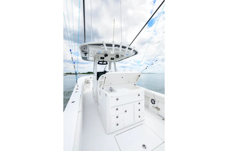 Slide: The Image of 2022 Regulator 34 Center Console boat interior with storage compartments and ocean view. - 18