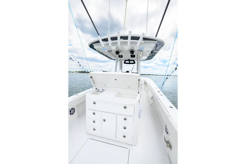 Slide: The Image of 2022 Regulator 34 Center Console boat interior with storage and fishing equipment. - 19