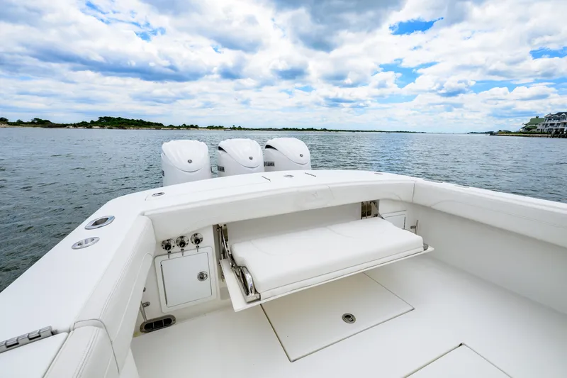 Slide: The Image of 2022 Regulator 34 Center Console boat with triple engines on calm water. - 21
