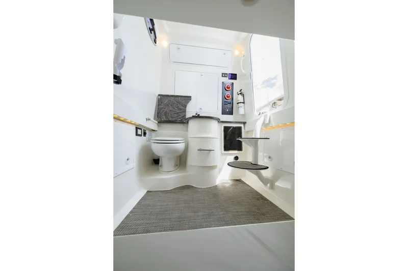 Slide: The Image of 2022 Regulator 34 Center Console boat interior with toilet and modern amenities. - 32