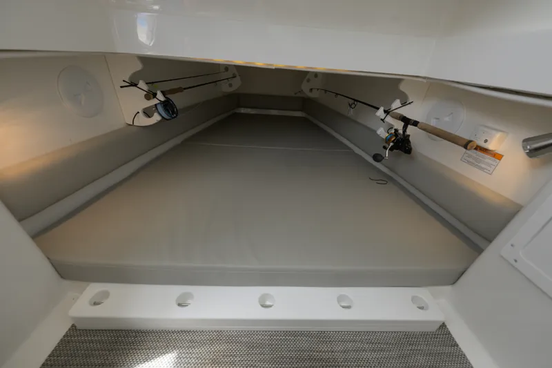 Slide: The Image of 2022 Regulator 34 Center Console cabin interior with fishing rod storage. - 33