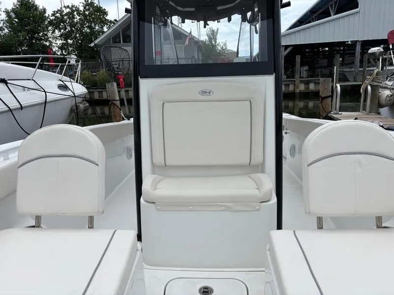Slide: The Image of The image shows the cockpit of a 2024 Sea Hunt Gamefish 25 boat with white seating. - 8