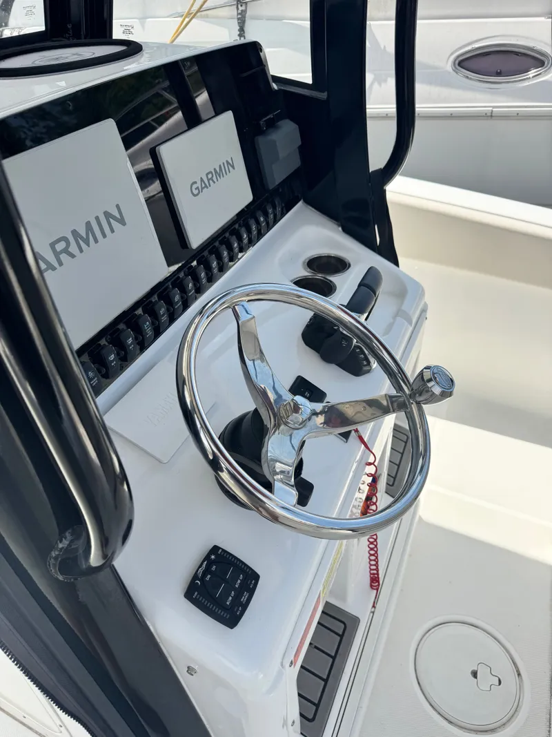 Slide: The Image of The image shows the helm of a Sea Hunt Gamefish 25 boat with Garmin electronics. - 12