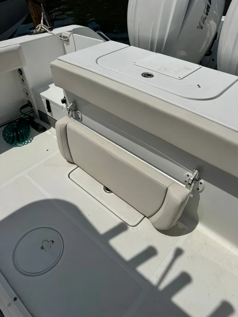 Slide: The Image of The image shows the cockpit of a Sea Hunt Gamefish 25 boat with a foldable bench seat. - 19