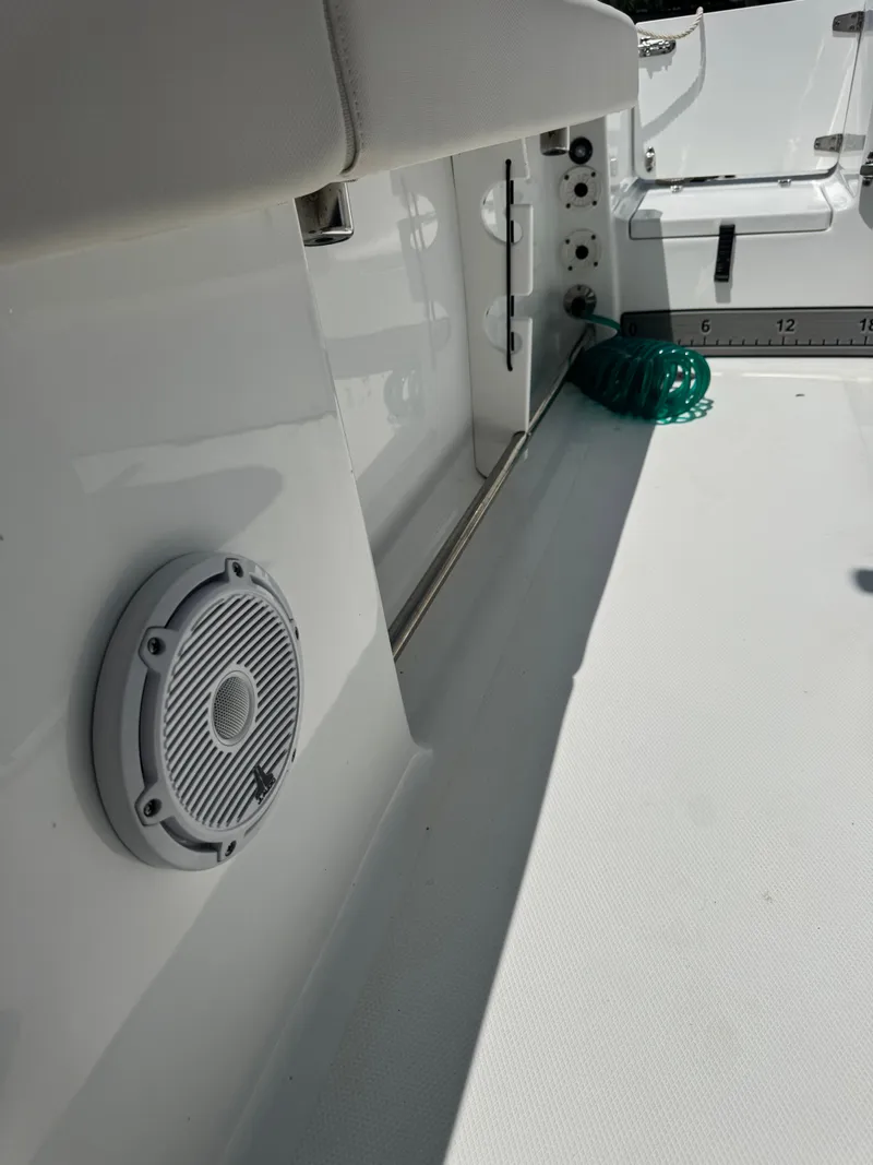 Slide: The Image of The image shows the deck of a Sea Hunt Gamefish 25 boat with a speaker and fishing rod holders. - 21