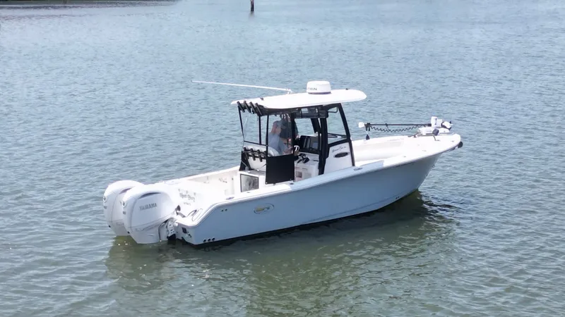 The Image of A 2024 Sea Hunt Gamefish 25 boat on calm water with twin outboard engines. - 0