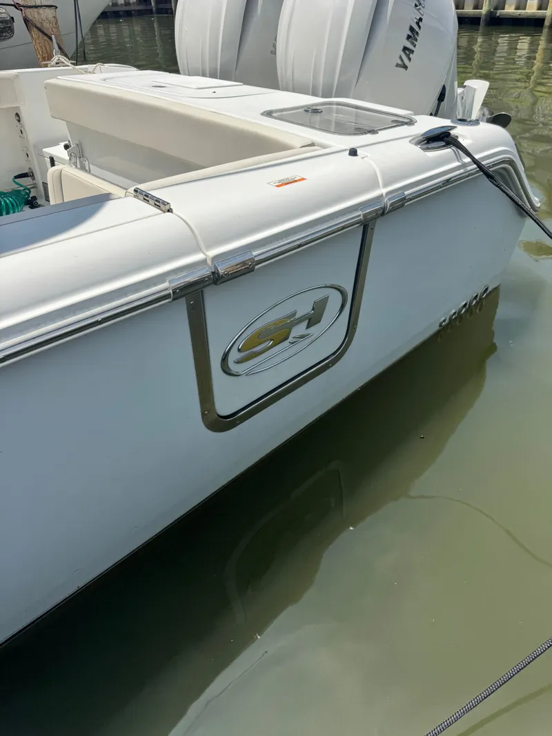 Slide: The Image of A 2024 Sea Hunt Gamefish 25 boat is docked in the water. It features a white exterior. - 5