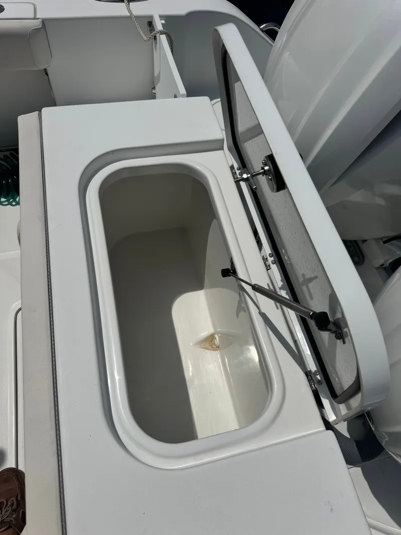 Slide: The Image of An open storage compartment on a 2024 Sea Hunt Gamefish 25 boat. - 20