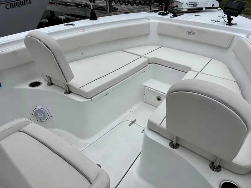 Slide: The Image of The image shows the seating area of a 2024 Sea Hunt Gamefish 25 boat with white upholstery. - 6