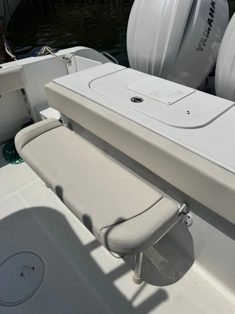 Slide: The Image of The image shows the cockpit of a 2024 Sea Hunt Gamefish 25 with a foldable bench seat. - 18