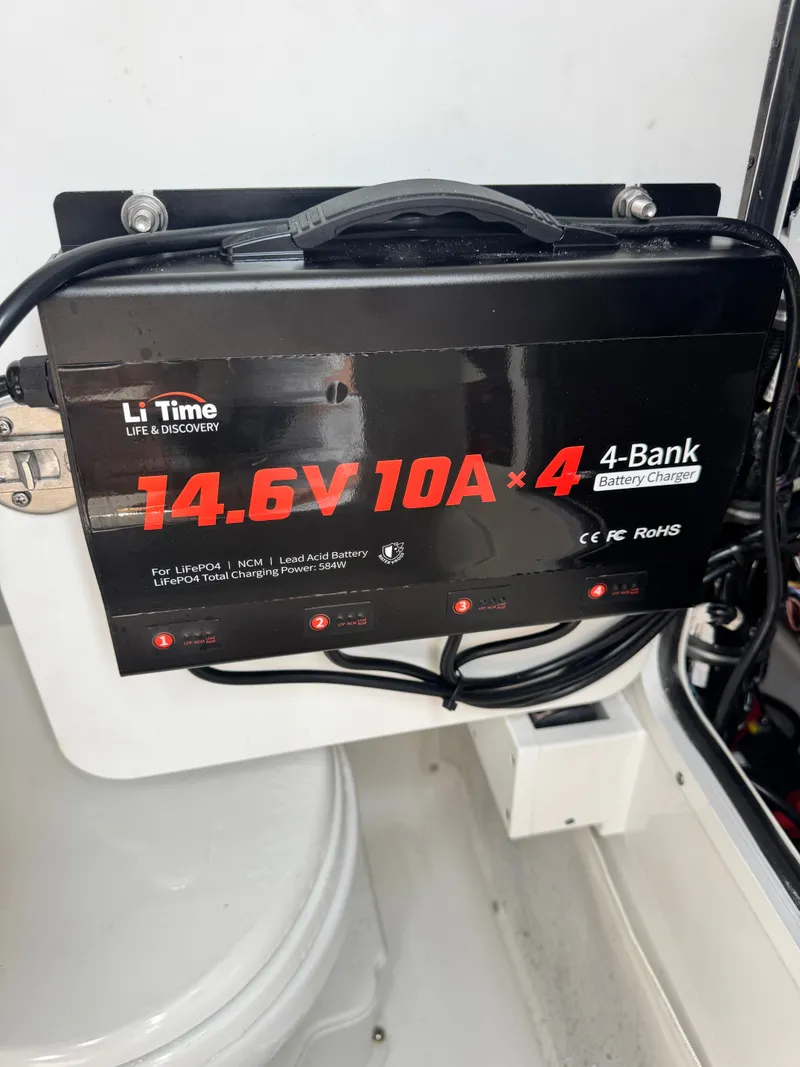 Slide: The Image of A 14.6V 10A 4-bank battery charger is installed in a boat. - 24