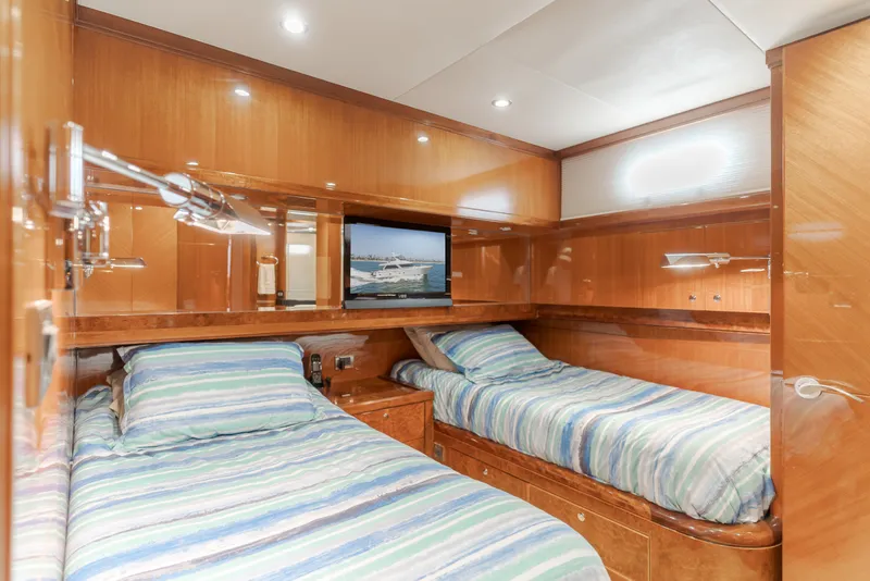 Slide: The Image of The 2010 Ocean Alexander 68 Motor Yacht cabin features twin beds and wooden walls. - 42