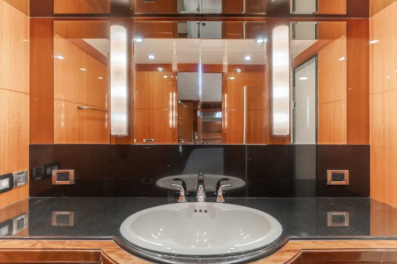 Slide: The Image of Luxurious bathroom with sink, mirror, and wood paneling on an Ocean Alexander 68 Motor Yacht. - 39