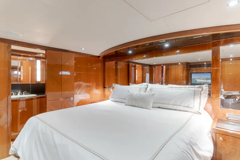 Slide: The Image of Luxurious bedroom with a large bed, glossy wood walls, and an adjoining bathroom. - 37