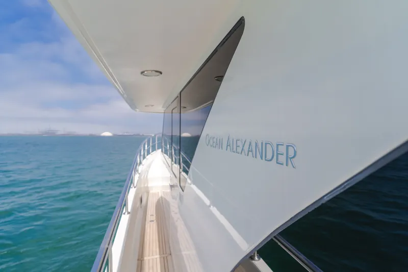 Slide: The Image of The 2010 Ocean Alexander 68 Motor Yacht glides elegantly over the blue water. - 23