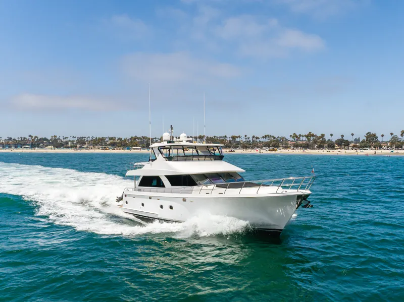 Slide: The Image of A luxurious white yacht speeds across blue waters, with a coastline visible in the background. - 11