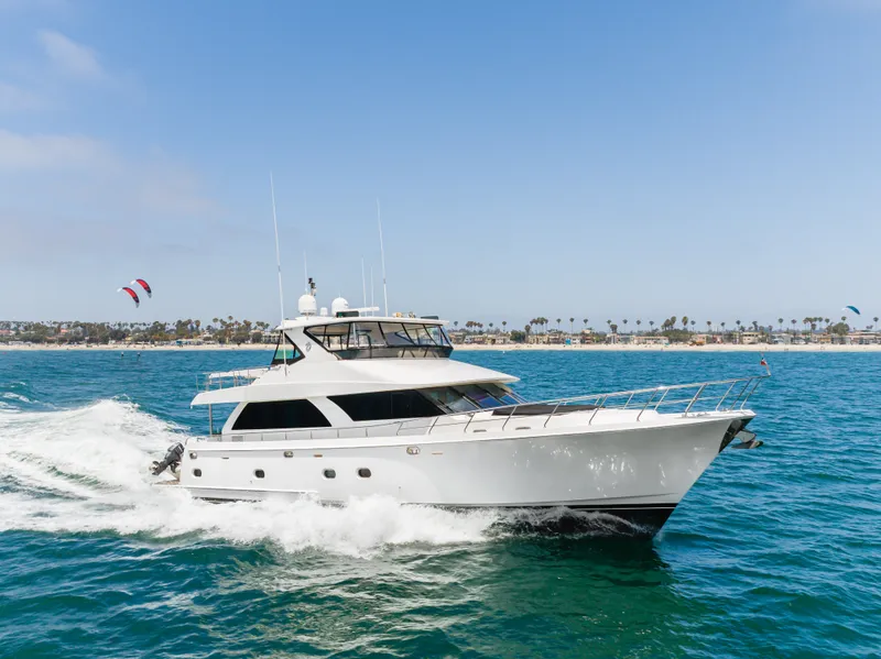 Slide: The Image of A luxurious 2010 Ocean Alexander 68 Motor Yacht cruising on the sea. The coastline is visible in the background. - 12