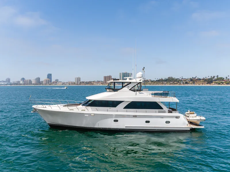 Slide: The Image of A luxurious white yacht cruises on calm waters with a city skyline in the background. - 8