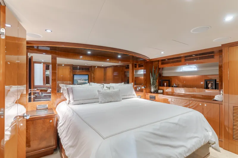 Slide: The Image of Luxurious bedroom with a large bed, wood-paneled walls, and elegant lighting on a yacht. - 36