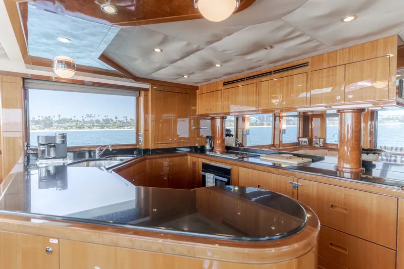 Slide: The Image of The 2010 Ocean Alexander 68 Motor Yacht's kitchen features elegant wood cabinetry and modern appliances. - 30