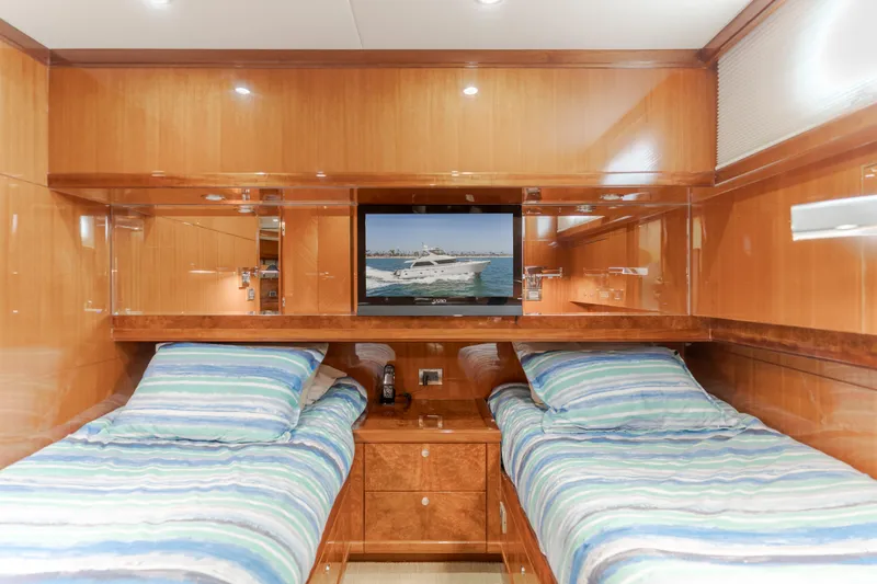 Slide: The Image of The cabin of the 2010 Ocean Alexander 68 Motor Yacht features two single beds with striped bedding. - 43