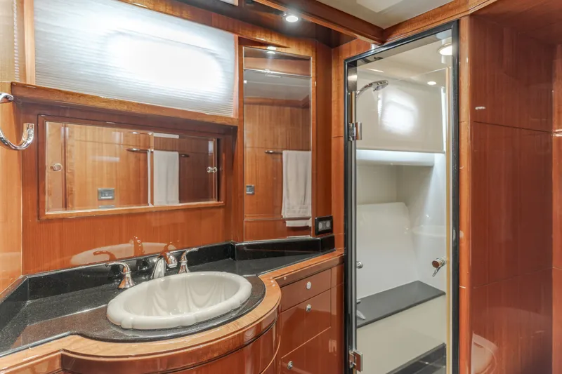 Slide: The Image of Luxurious bathroom with wood paneling, sink, mirror, and shower in a yacht. - 45
