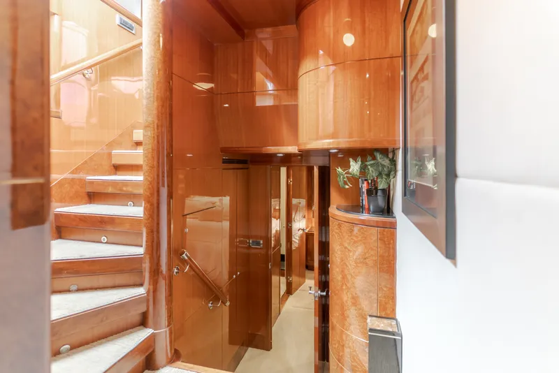 Slide: The Image of Luxurious interior of a 2010 Ocean Alexander 68 Motor Yacht with glossy wood walls and stairs. - 35