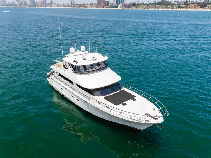Slide: The Image of A luxurious white yacht on calm waters, with a city skyline in the background. - 10