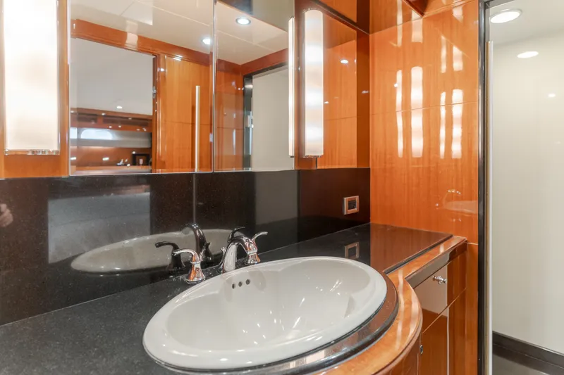 Slide: The Image of The image shows an elegant bathroom with a sink, glossy wood paneling, and a large mirror. - 40