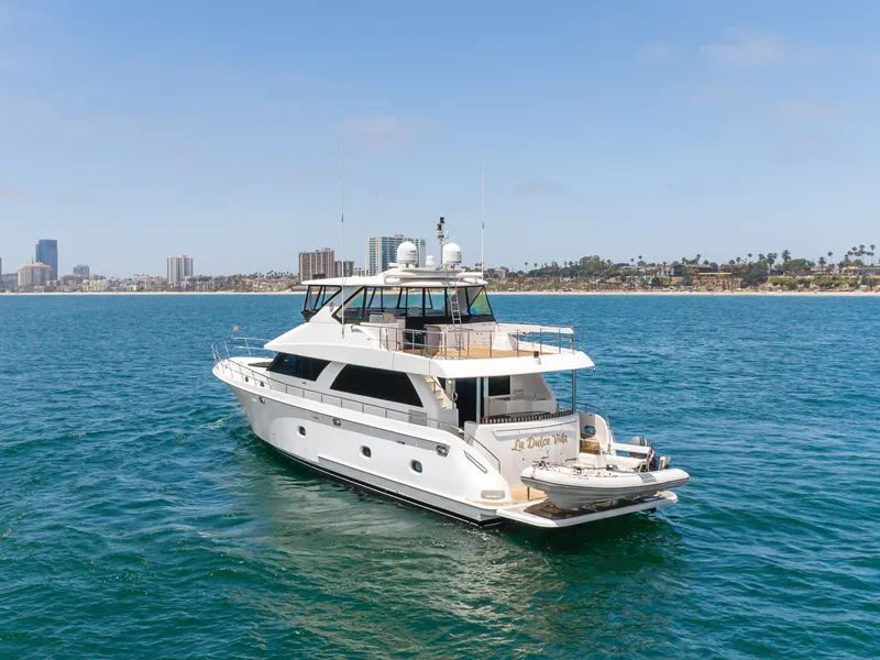 Slide: The Image of A luxurious 2010 Ocean Alexander motor yacht cruising on calm waters near a coastline. - 2