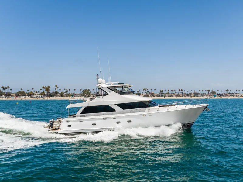 Slide: The Image of A luxurious white yacht speeds across blue waters, with a coastline visible in the background. - 13